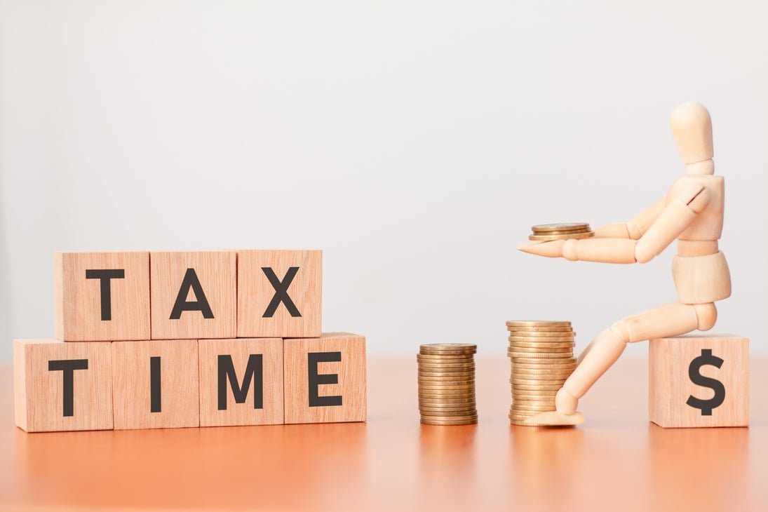 Smart strategies for tax season: A wooden dummy that stacks coins at tax time.